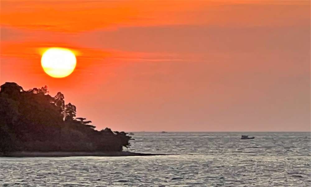 Illegal trawler boat trawling at sunset