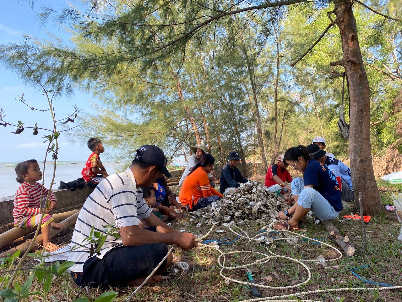 Cambodian young girls showing their octopus drawings at the end of our outreach session